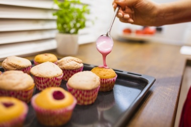 gallery/crop-hand-pouring-sauce-onto-muffins_23-2147758321